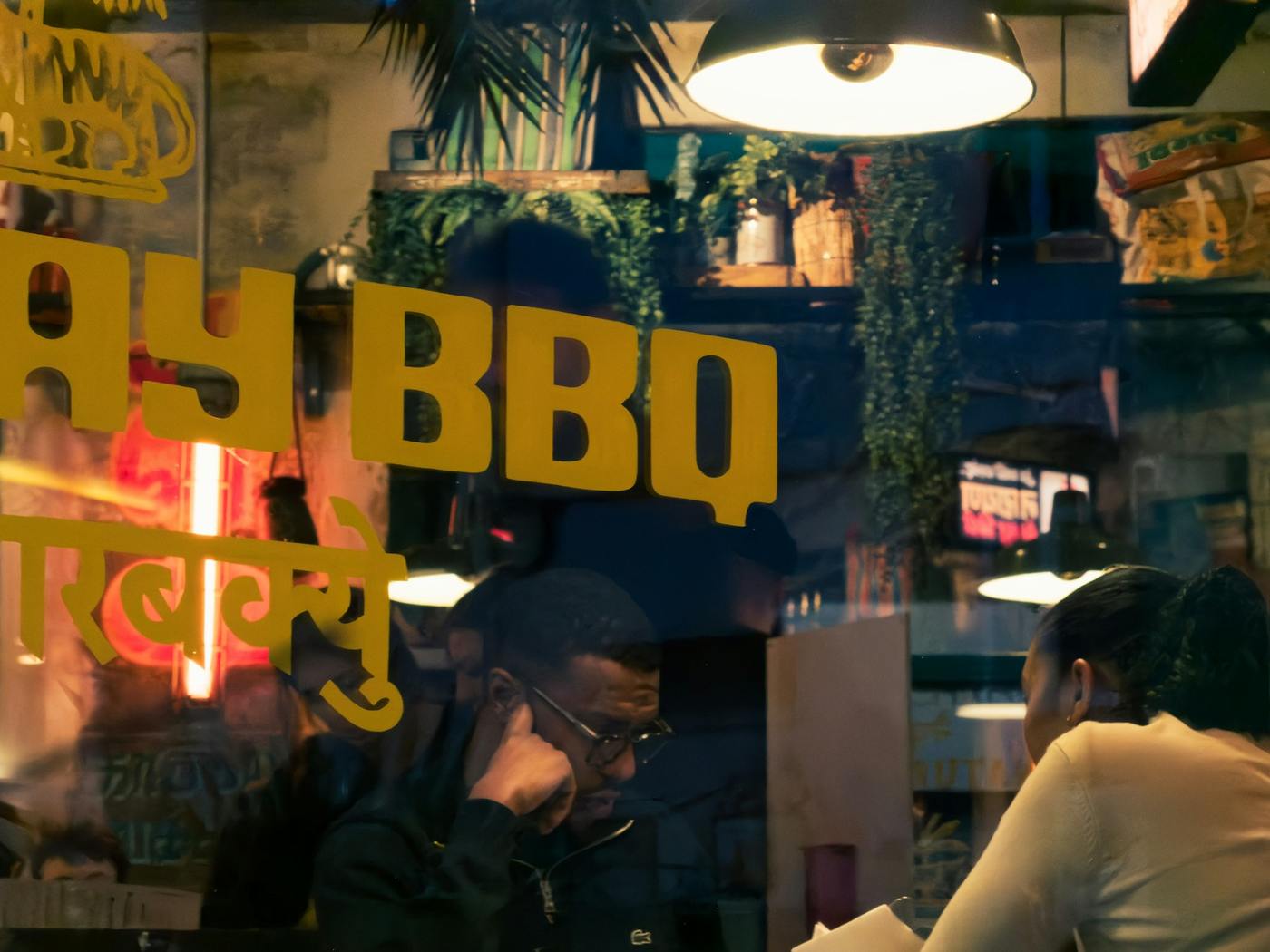 People eating at tables inside a busy restaurant.